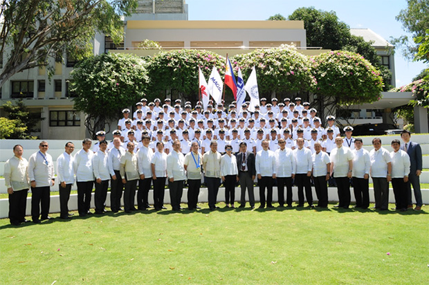 Graduates pose for a photo with guests